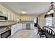 The bright kitchen area has stainless appliances, tile floors, and white cabinets at 1450 Pinyon Pl, Lawrenceville, GA 30043