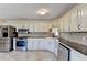 Kitchen with stainless steel appliances, countertops and painted cabinets at 1450 Pinyon Pl, Lawrenceville, GA 30043