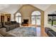 View of living room, including the hardwood floor, fireplace, and large windows at 1450 Pinyon Pl, Lawrenceville, GA 30043