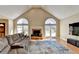 Living room view of arched windows, wood floor and fireplace at 1450 Pinyon Pl, Lawrenceville, GA 30043