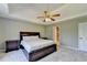 Spacious main bedroom features a trey ceiling, ceiling fan, neutral colors, and lots of natural light at 1450 Pinyon Pl, Lawrenceville, GA 30043