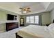 Spacious main bedroom features a trey ceiling, ceiling fan, neutral colors, and lots of natural light at 1450 Pinyon Pl, Lawrenceville, GA 30043