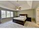 Spacious main bedroom suite features a trey ceiling, ceiling fan, neutral colors, and lots of natural light at 1450 Pinyon Pl, Lawrenceville, GA 30043
