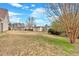 Wide backyard view with a storage shed nestled in the landscape, offering additional storage and outdoor space at 251 Bent Creek Dr, Dallas, GA 30157