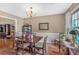 Bright dining room featuring neutral paint, chair railing and a large dark wood table at 251 Bent Creek Dr, Dallas, GA 30157