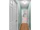 Hallway view featuring a light green wall with white doors on either side of the hall, and carpet flooring at 251 Bent Creek Dr, Dallas, GA 30157