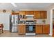 Functional kitchen with oak cabinets, gas range, stainless steel fridge, and ample storage at 251 Bent Creek Dr, Dallas, GA 30157