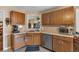Modern kitchen with oak cabinets, stainless steel dishwasher, and neutral countertops at 251 Bent Creek Dr, Dallas, GA 30157