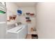 Well-equipped laundry room with washer, dryer, water heater, and shelving for storage at 251 Bent Creek Dr, Dallas, GA 30157