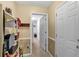 Functional pantry with shelving, a storage cabinet and view to a hallway for easy access at 251 Bent Creek Dr, Dallas, GA 30157