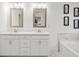 Bathroom with double sinks, white cabinets, and marble-look flooring at 2855 Mcmurtry St, Cumming, GA 30041