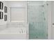 Elegant bathroom with marble tiling, soaking tub, and glass enclosed shower at 2855 Mcmurtry St, Cumming, GA 30041