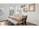 Dining room featuring a wooden table, stylish chairs, bench seating, and modern wall decor at 2855 Mcmurtry St, Cumming, GA 30041