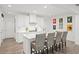 A bright kitchen features white cabinets, stainless steel appliances, and breakfast bar seating at 2855 Mcmurtry St, Cumming, GA 30041