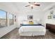 Bright main bedroom featuring large windows, hardwood floors, and white ceiling at 2855 Mcmurtry St, Cumming, GA 30041