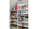 Well-organized pantry with multiple shelves filled with various food and household items at 2855 Mcmurtry St, Cumming, GA 30041