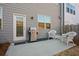 Outdoor patio featuring wicker furniture, grill, and gray siding on the house at 2855 Mcmurtry St, Cumming, GA 30041