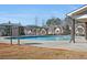 Community swimming pool with sunshade and houses in the background at 2855 Mcmurtry St, Cumming, GA 30041