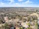 Aerial view of residential properties nestled within a forest, showcasing a serene and wooded neighborhood at 6920 Greenfield Ln, Cumming, GA 30028