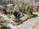 This aerial view showcases a community pool with lounging area and surrounding trees and street access at 6920 Greenfield Ln, Cumming, GA 30028