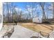 View of backyard with shed, patio, and chairs at 6920 Greenfield Ln, Cumming, GA 30028