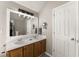 Double vanity bathroom features a large mirror and natural-look cabinetry for storage at 6920 Greenfield Ln, Cumming, GA 30028