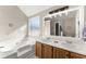 This luxurious bathroom features a soaking tub and double vanity for convenience at 6920 Greenfield Ln, Cumming, GA 30028
