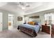 Large primary bedroom with tray ceiling, and ensuite bath offer a private retreat at 6920 Greenfield Ln, Cumming, GA 30028