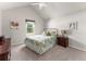 Cozy bedroom with a vaulted ceiling, floral bedding, and a bright window perfect for relaxing at 6920 Greenfield Ln, Cumming, GA 30028