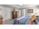Bedroom with a striped comforter, and ample storage with two closets and a dresser at 6920 Greenfield Ln, Cumming, GA 30028