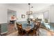 Sunlit dining area features wood floors and a bay window perfect for Gathering meals and entertaining guests at 6920 Greenfield Ln, Cumming, GA 30028