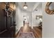 Inviting foyer with hardwood floors, neutral walls, and decorative accents at 6920 Greenfield Ln, Cumming, GA 30028