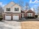 Charming two-story home with a brick and vinyl exterior and well-maintained lawn at 6920 Greenfield Ln, Cumming, GA 30028