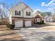 Charming two-story home with a brick and vinyl exterior and dormant lawn at 6920 Greenfield Ln, Cumming, GA 30028