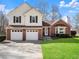 Charming two-story home with a brick and vinyl exterior and well-maintained lawn at 6920 Greenfield Ln, Cumming, GA 30028