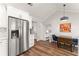 Open kitchen featuring stainless steel appliances, white cabinetry, and vaulted ceilings for an airy feel at 6920 Greenfield Ln, Cumming, GA 30028
