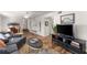 Cozy living room features a plush sofa, wood floors, and a mounted television at 6920 Greenfield Ln, Cumming, GA 30028