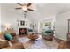 Bright living room featuring vaulted ceilings, a cozy fireplace, and comfortable seating at 6920 Greenfield Ln, Cumming, GA 30028