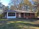 Charming single-story brick home with well-maintained lawn and mature trees providing shade at 121 Mcgiboney Rd, Covington, GA 30016