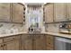 Kitchen sink with custom cabinets, granite countertops, and stainless steel appliances at 3202 Eagle Watch Dr, Woodstock, GA 30189