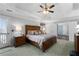 Spacious main bedroom with tray ceiling, deck access, and ensuite bath at 3202 Eagle Watch Dr, Woodstock, GA 30189