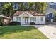 Charming white-painted home features a well-manicured lawn and a welcoming front entrance with natural lighting at 618 Daniel Ave, Decatur, GA 30032