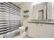 Bathroom featuring a granite-topped vanity and a shower-tub with a striped curtain at 840 Wells Se Cir, Smyrna, GA 30080