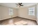 Cozy bedroom with wood-look floors, neutral walls, and natural light from two windows at 840 Wells Se Cir, Smyrna, GA 30080