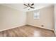 Bedroom featuring modern ceiling fan, wood-look floors, and a bright window at 840 Wells Se Cir, Smyrna, GA 30080