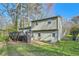 Rear exterior view of the home showing siding, a wooden deck, and a walkout basement door at 840 Wells Se Cir, Smyrna, GA 30080