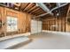 Unfinished garage space with exposed wood framework, painted floor, window, and a white garage door at 840 Wells Se Cir, Smyrna, GA 30080