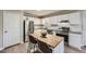 Modern kitchen featuring stainless steel appliances, white cabinets, and a stylish center island at 840 Wells Se Cir, Smyrna, GA 30080