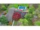 Aerial view of a home featuring an in-ground pool, lush landscaping, and inviting outdoor seating areas at 311 Maranatha Trl, Lawrenceville, GA 30045
