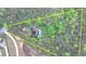 Aerial view showcasing the home's location within a large property surrounded by dense trees and foliage at 311 Maranatha Trl, Lawrenceville, GA 30045
